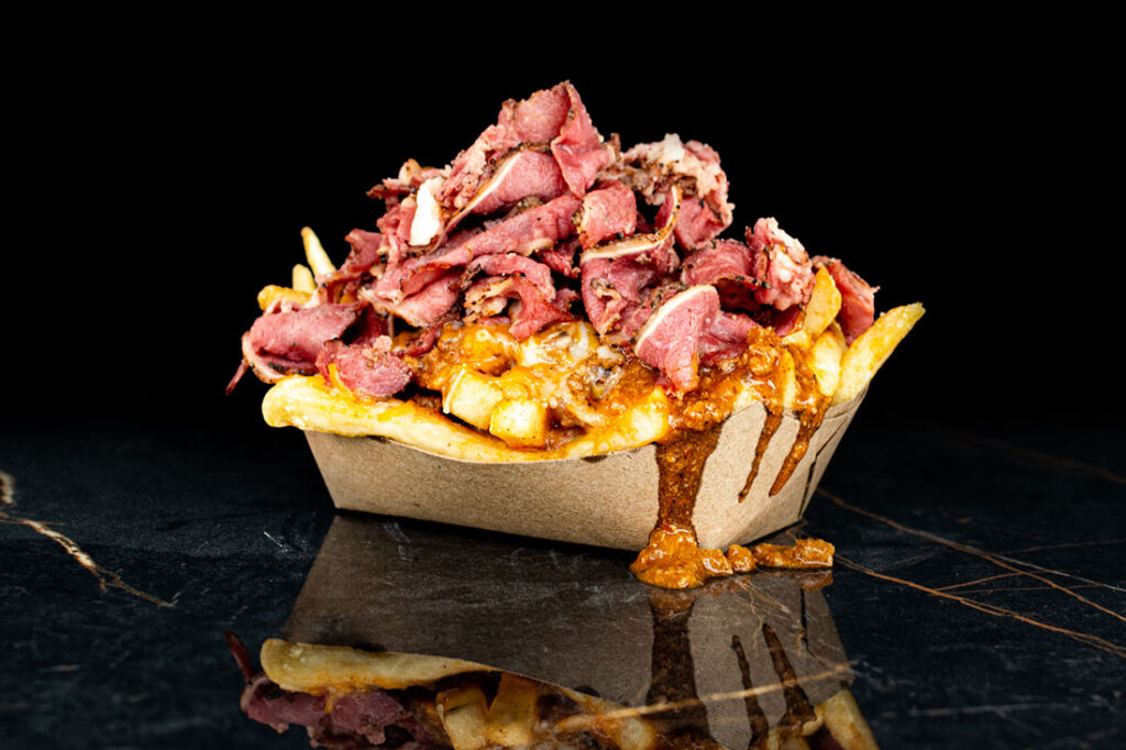 mamba fries topped with house chili, cheddar cheese, and pastrami